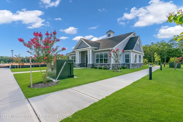 a view of a house with a swimming pool and a yard