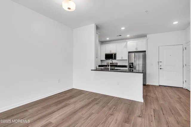 a view of kitchen with wooden floor