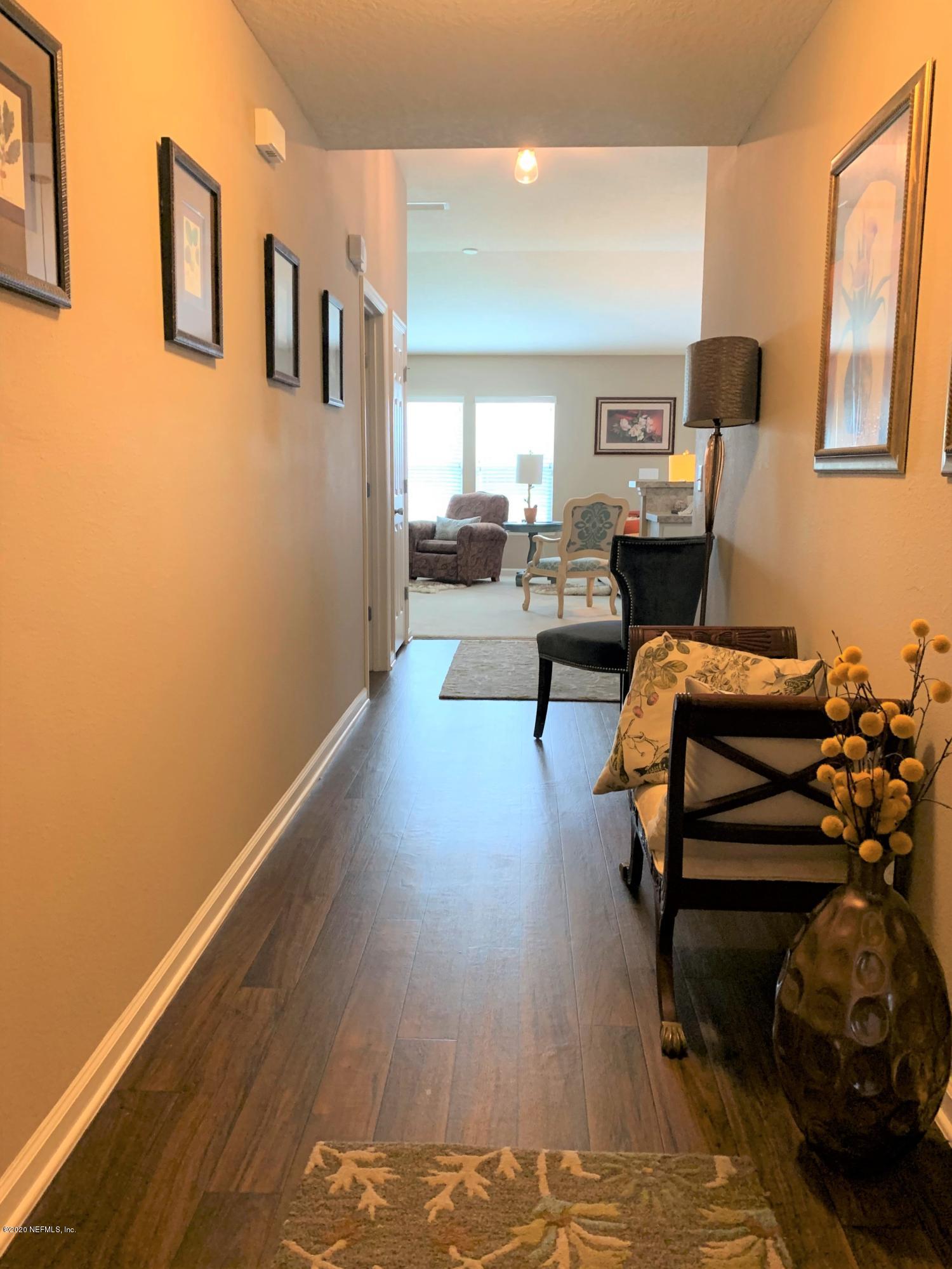 16007 Hutton Lane Jacksonville, FL 32218 - Photo 15 of 29 a living room with furniture and a wooden floor