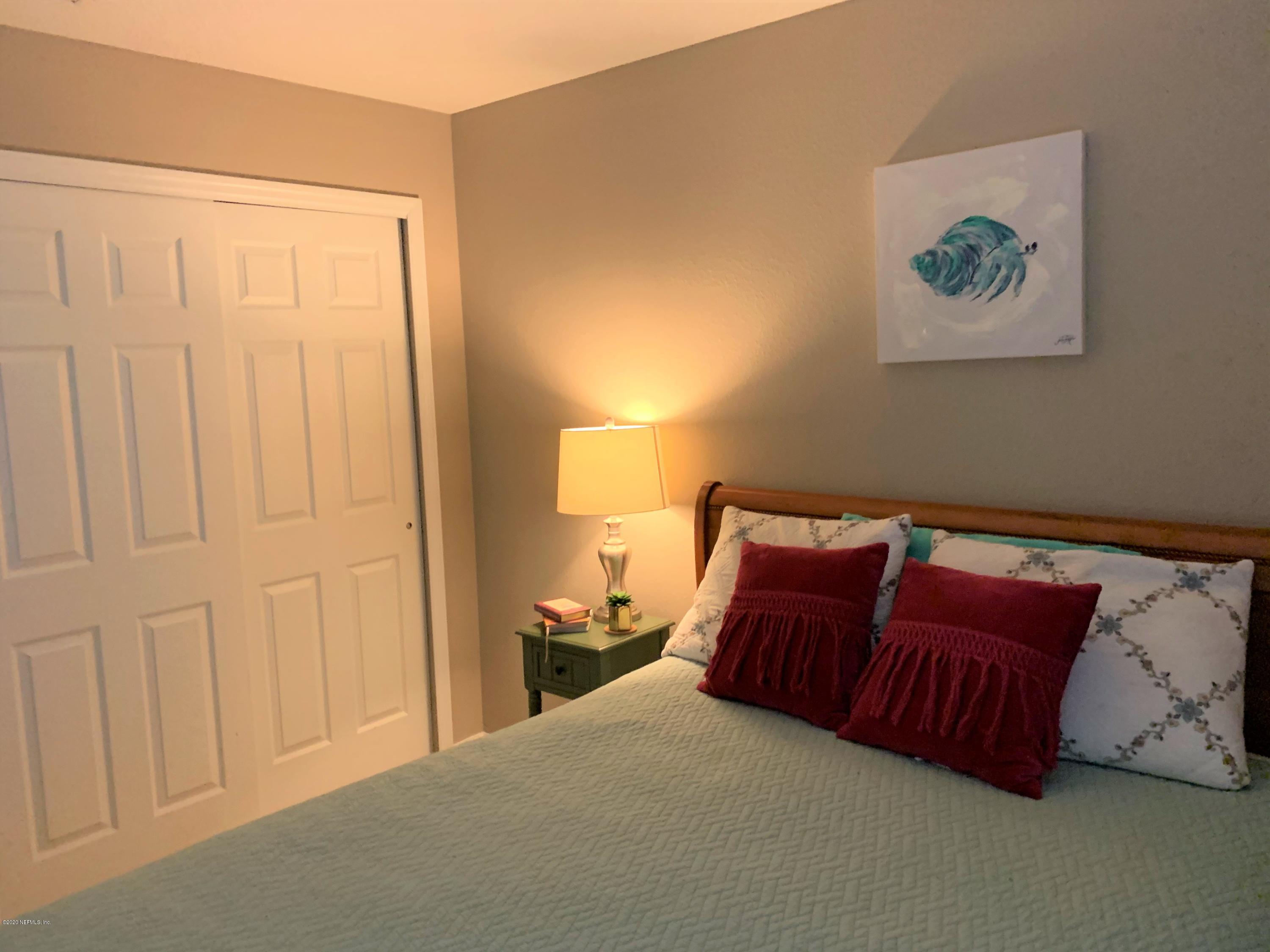 16007 Hutton Lane Jacksonville, FL 32218 - Photo 18 of 29 a bedroom with a bed and a painting on the wall