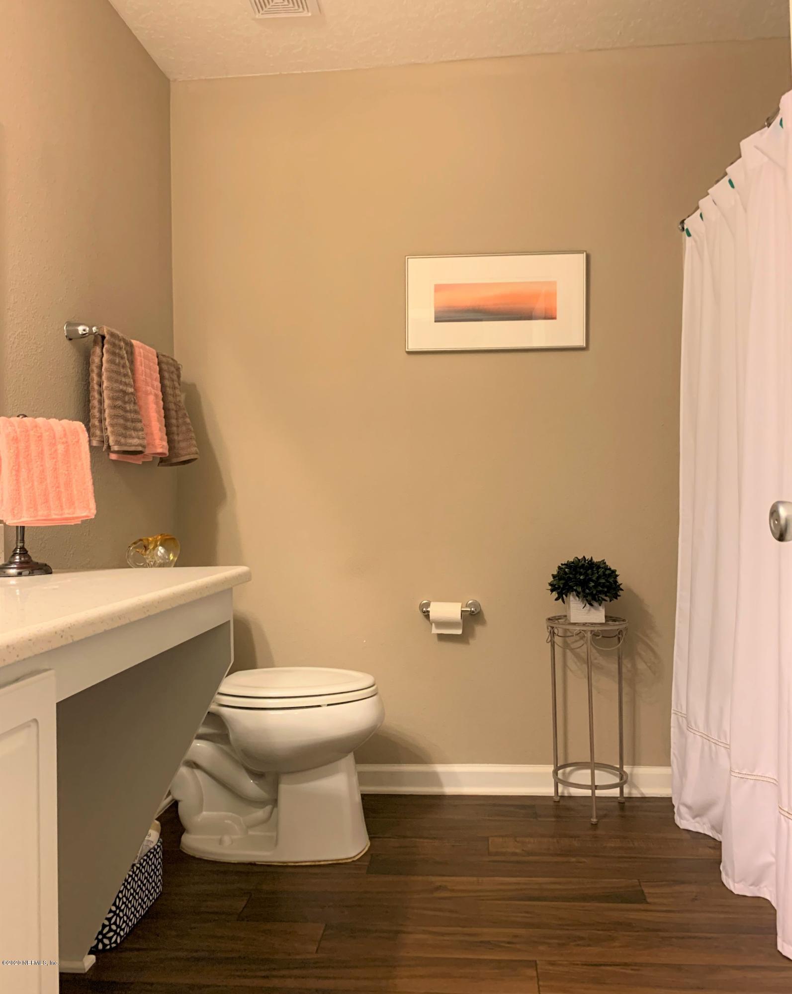 16007 Hutton Lane Jacksonville, FL 32218 - Photo 20 of 29 a bathroom with a toilet a sink and mirror