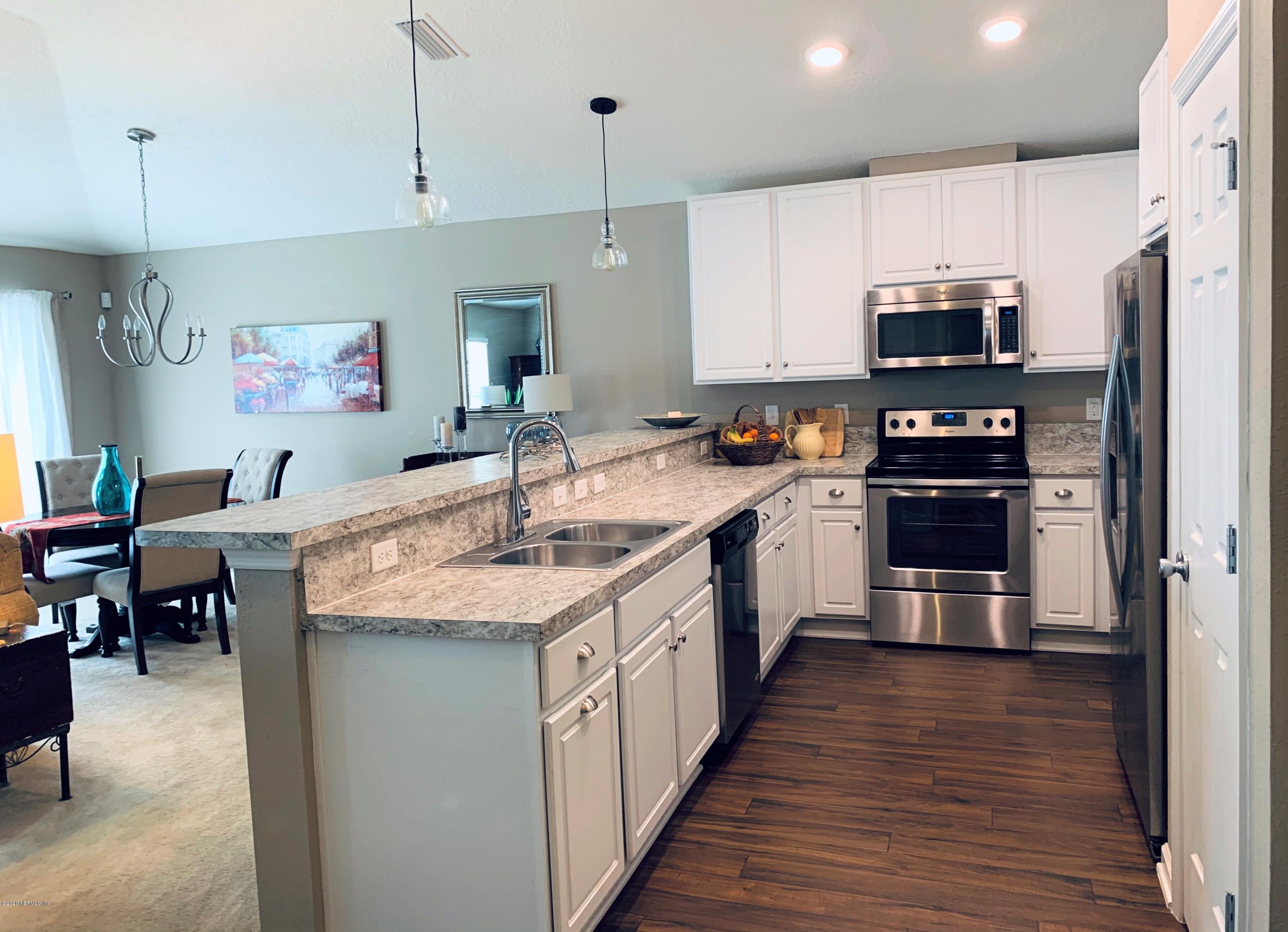 16007 Hutton Lane Jacksonville, FL 32218 - Photo 5 of 29 a kitchen with stainless steel appliances granite countertop a sink and a refrigerator