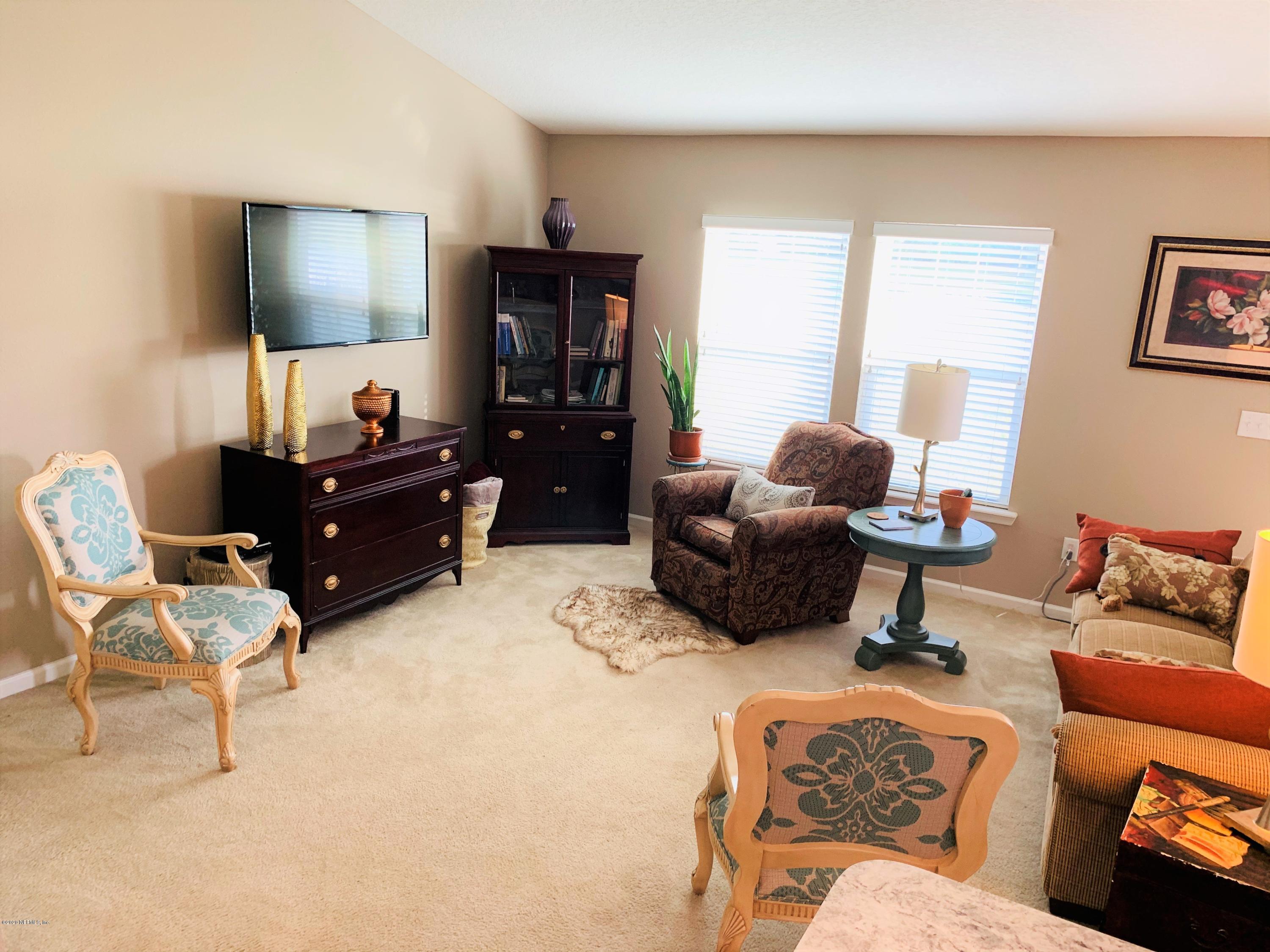 16007 Hutton Lane Jacksonville, FL 32218 - Photo 10 of 29 a living room with furniture and a flat screen tv
