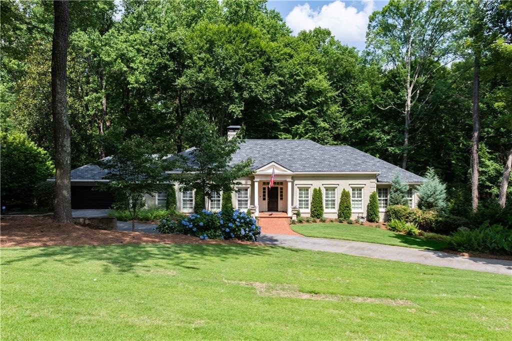 3620 Paces Valley Road Northwest Atlanta, GA 30327 - Photo 1 of 1 a front view of a house with a yard