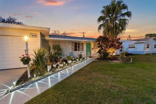 a view of a house with a backyard