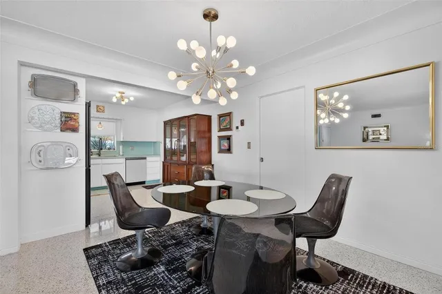 a view of a dining room with furniture and chandelier