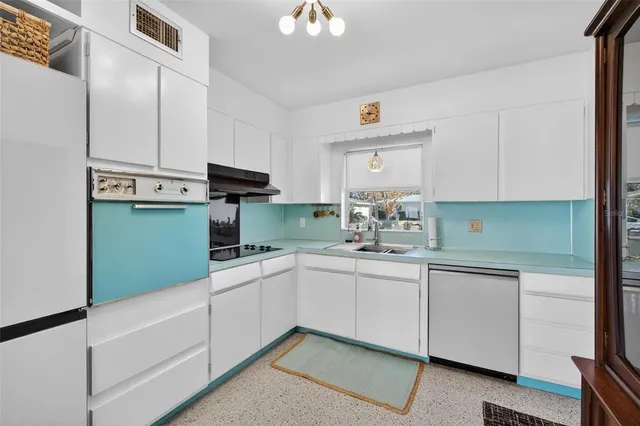 a kitchen with a sink cabinets and stainless steel appliances