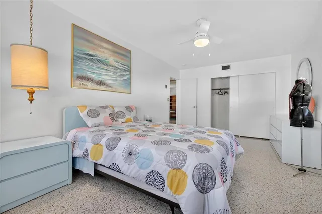 a bedroom with a bed and lamp