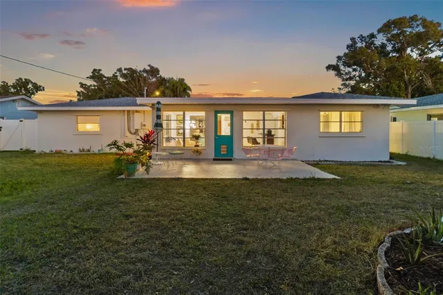 a view of a house with table and chairs