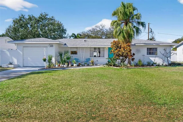 a front view of house with yard and outdoor seating