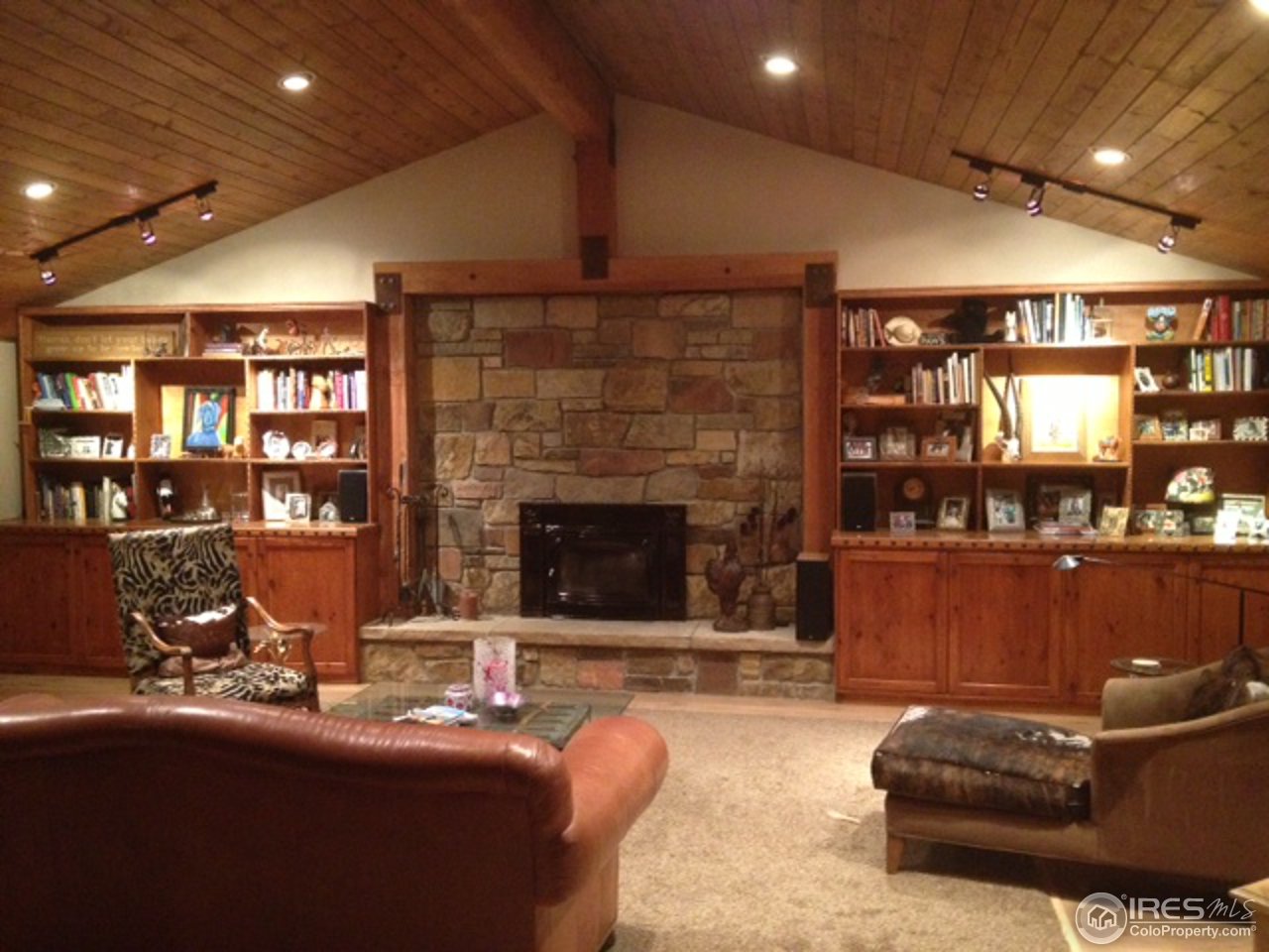 a living room with furniture a large window and bookshelf
