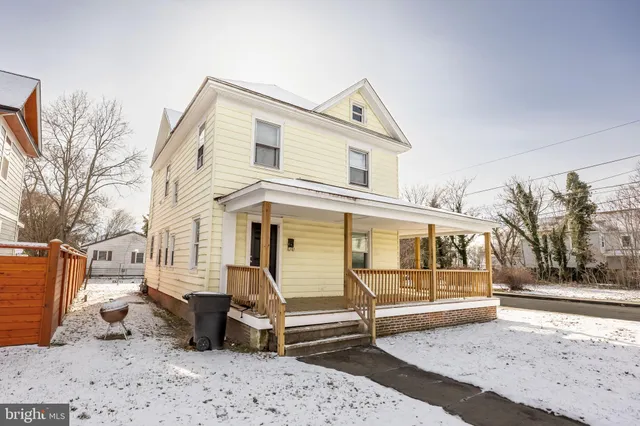 a view of a white house with a large window