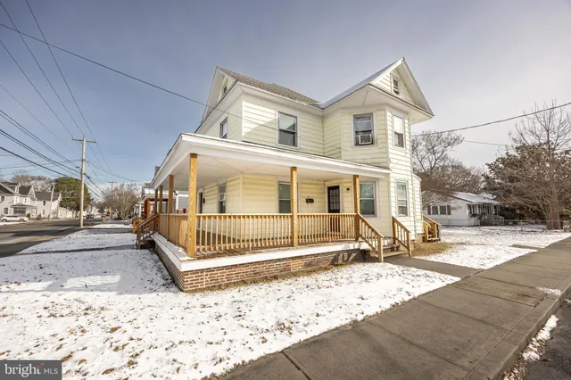 a view of a house with wooden fence