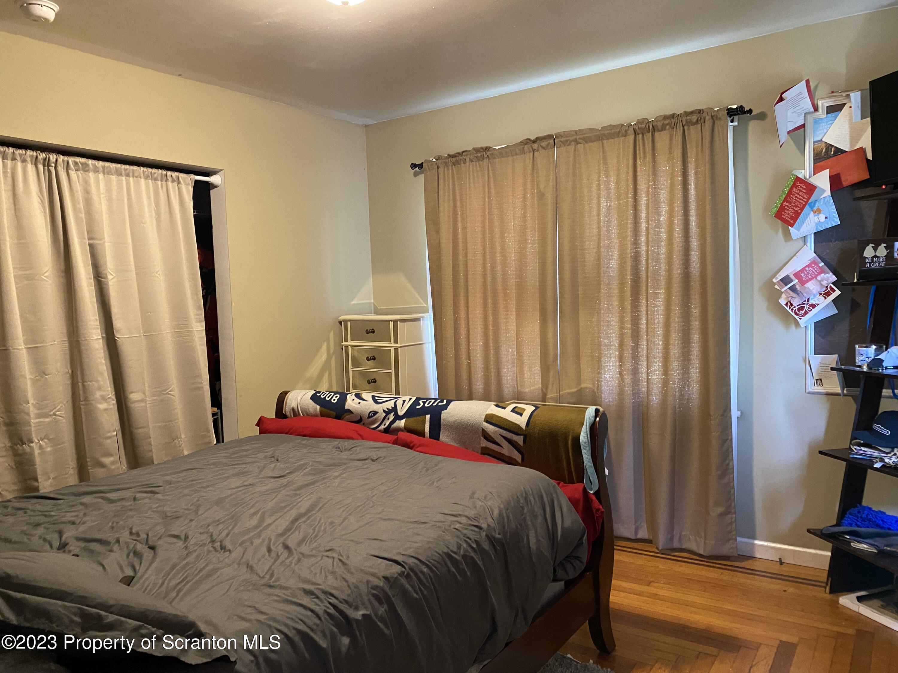 1058 Interchange Road Gilbert, PA 18331 - Photo 12 of 17 a bed sitting in a bedroom next to a window and a bookshelf