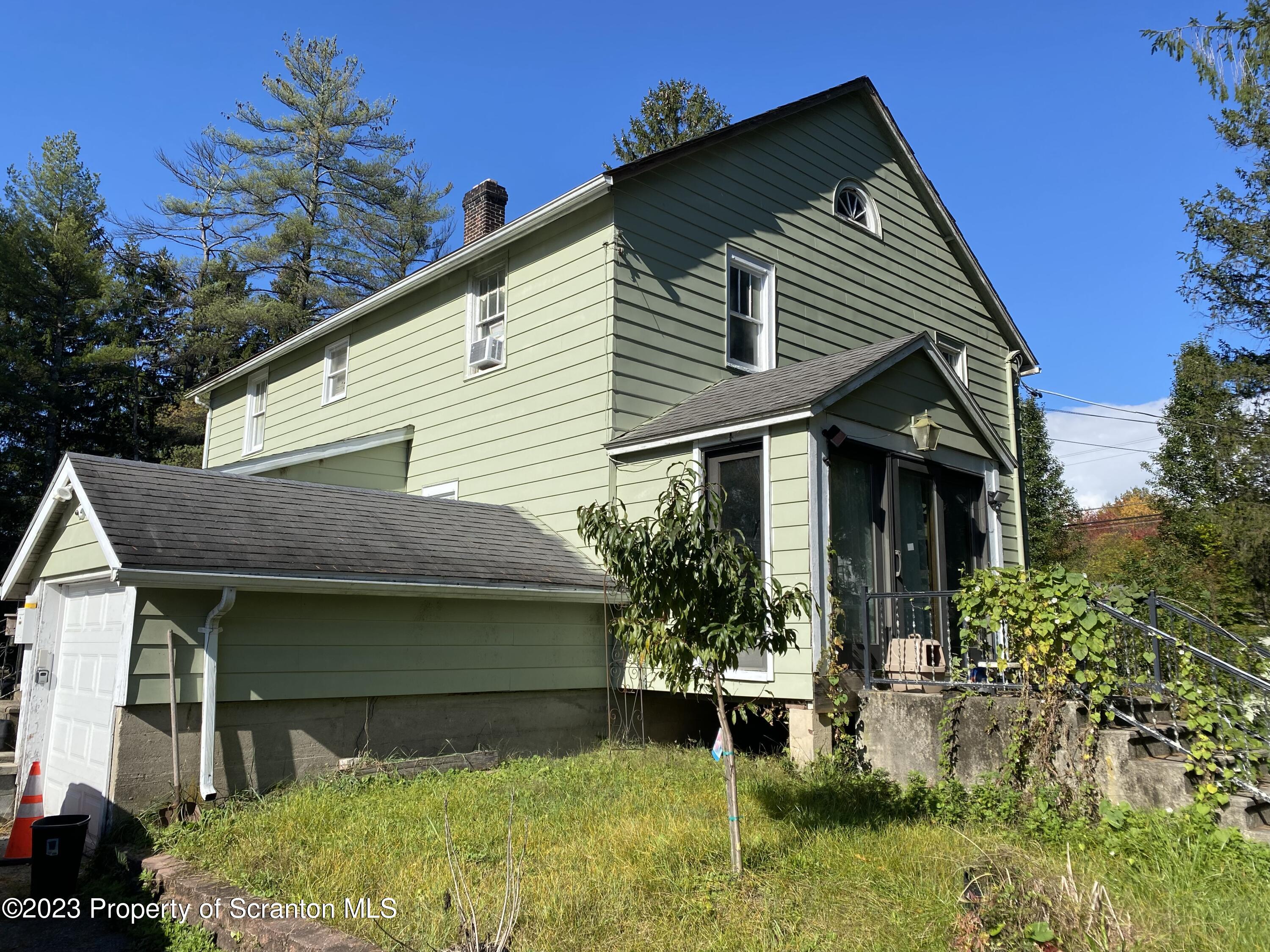 1058 Interchange Road Gilbert, PA 18331 - Photo 2 of 17 a front view of a house with garden