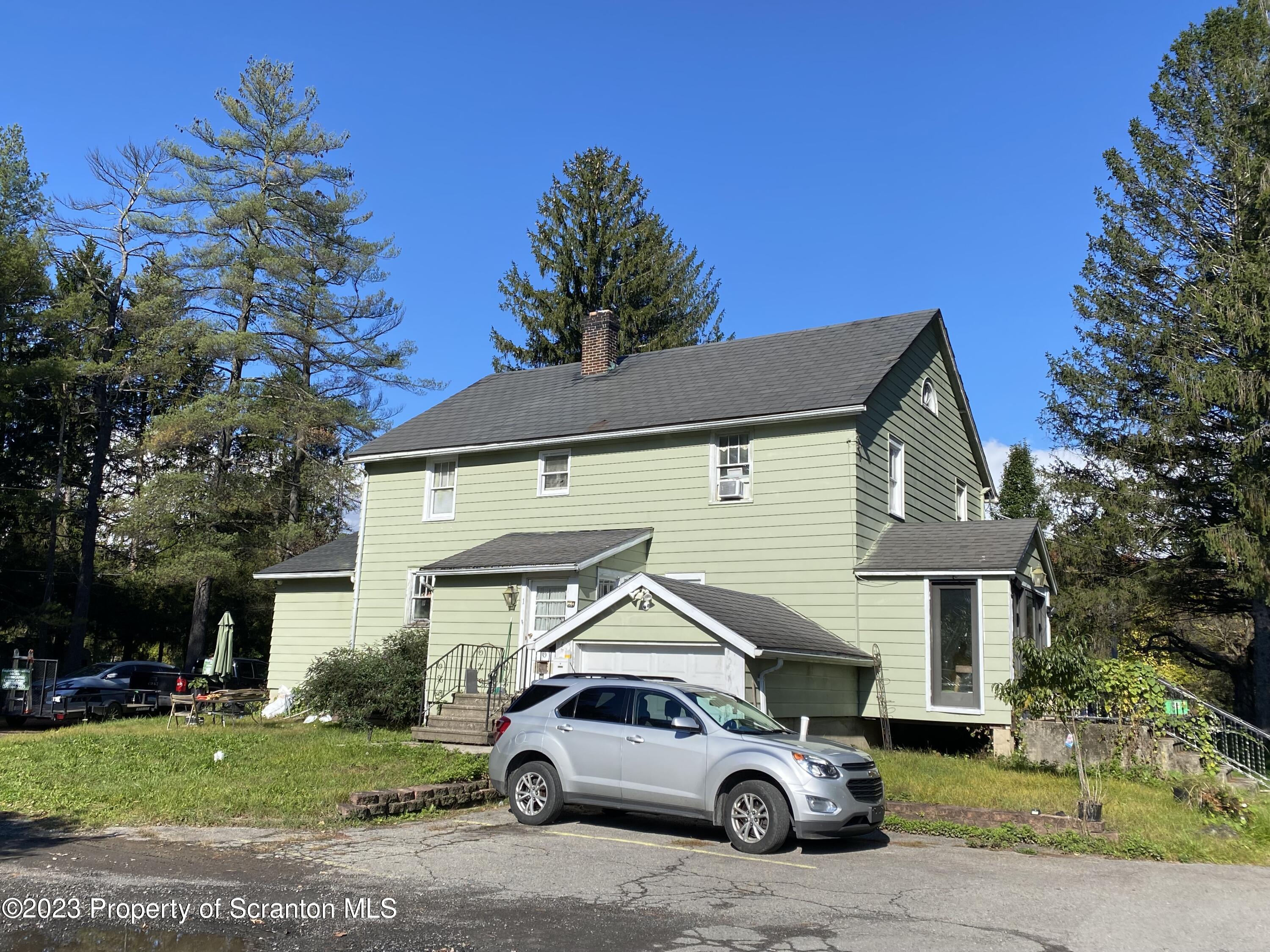 1058 Interchange Road Gilbert, PA 18331 - Photo 3 of 17 a car parked in front of a house
