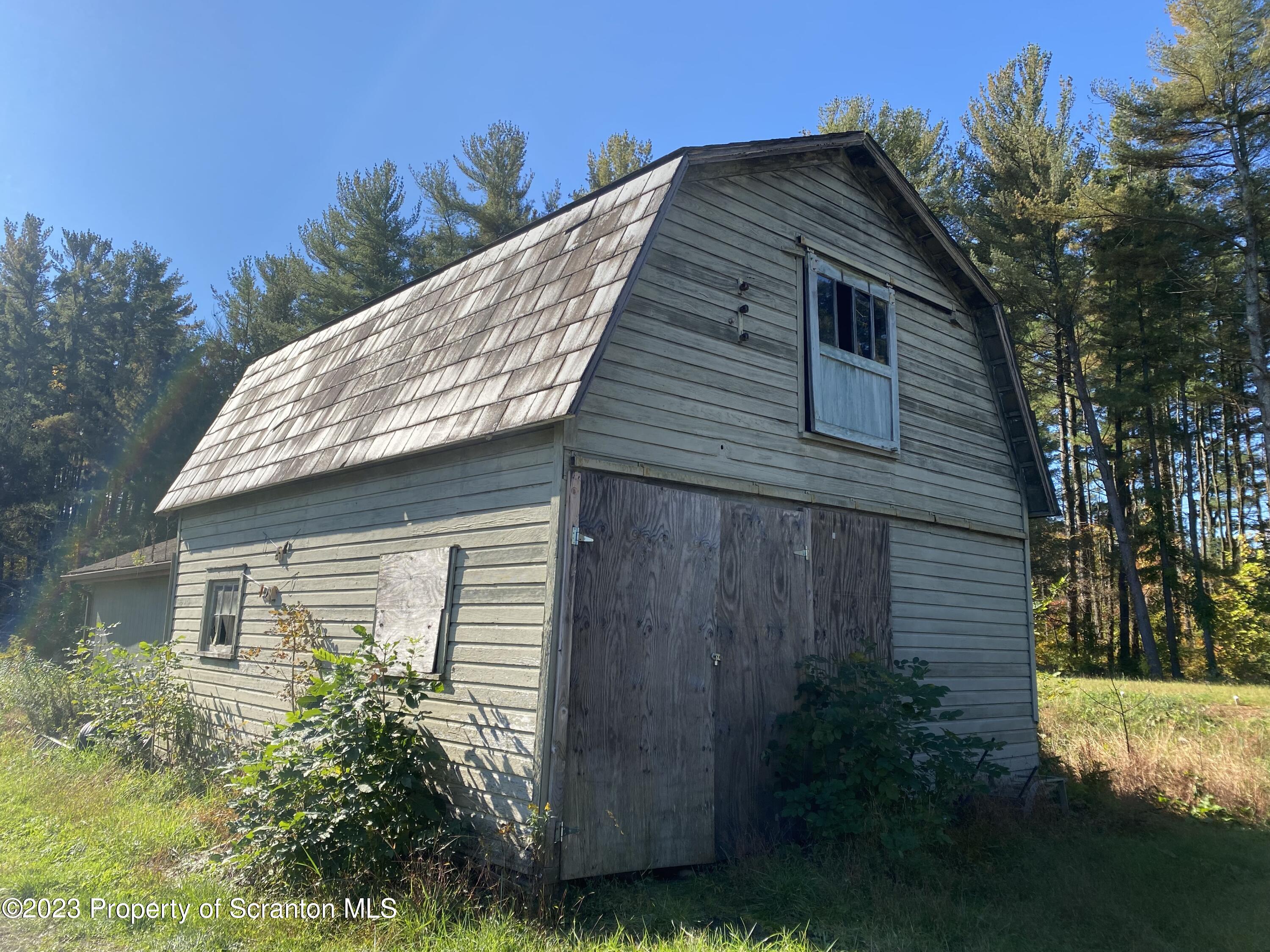 1058 Interchange Road Gilbert, PA 18331 - Photo 5 of 17 a front view of a house with garden