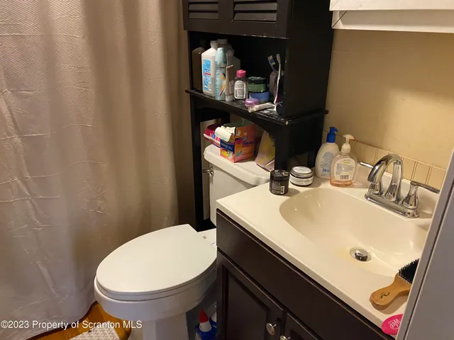 a bathroom with a sink toilet and vanity