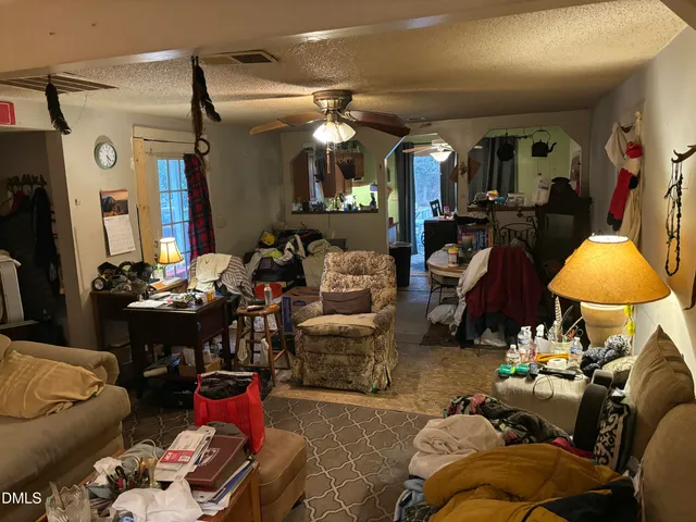 a living room with furniture and a lamp