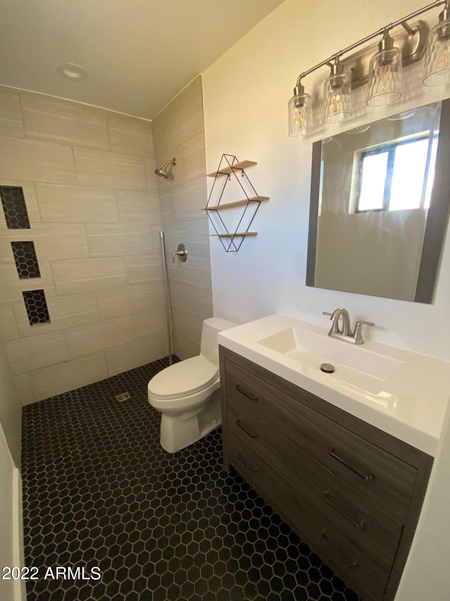 3244 West Yucca Street Phoenix, AZ 85029 - Photo 18 of 21 a bathroom with a sink and a mirror