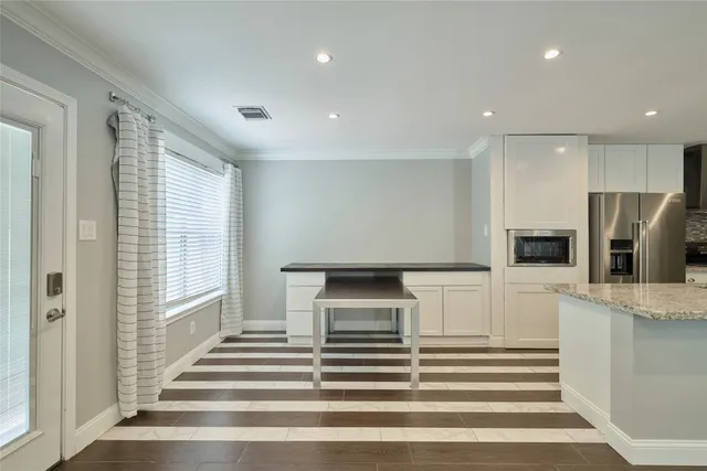 a view of a kitchen with a refrigerator and a stove