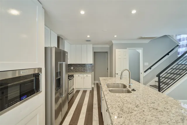 a kitchen with a refrigerator sink and stove