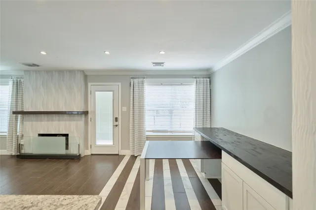 a view of an empty room with a fireplace and a window