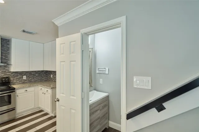 a view of a kitchen from the hallway