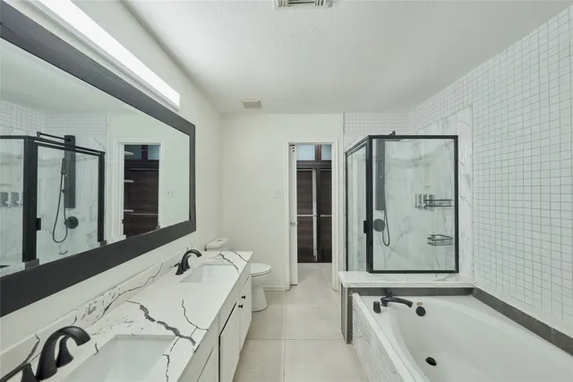 a bathroom with a tub sink and mirror