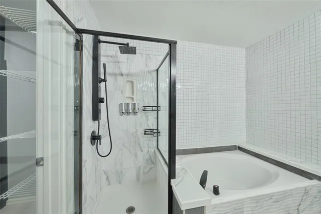 a bathroom with a tub and a shower