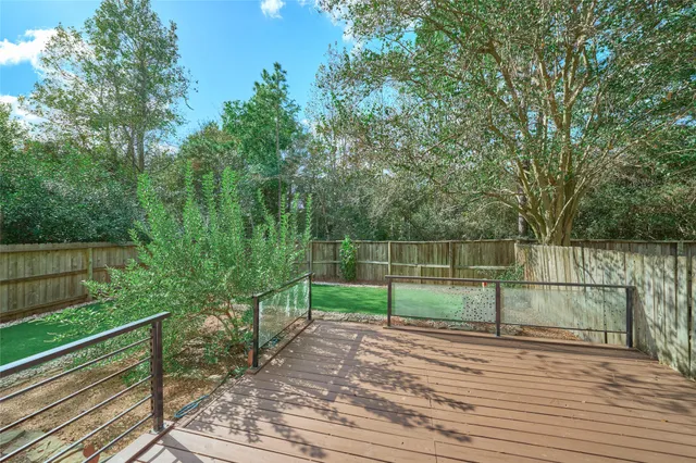 a view of backyard with a garden and deck