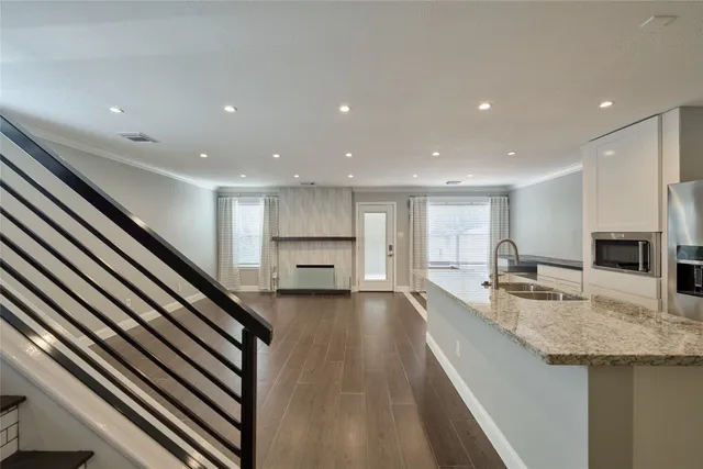 a view of a kitchen with kitchen island a sink stainless steel appliances and a counter top