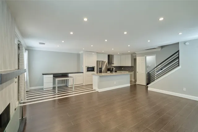 a view of empty room with wooden floor and window