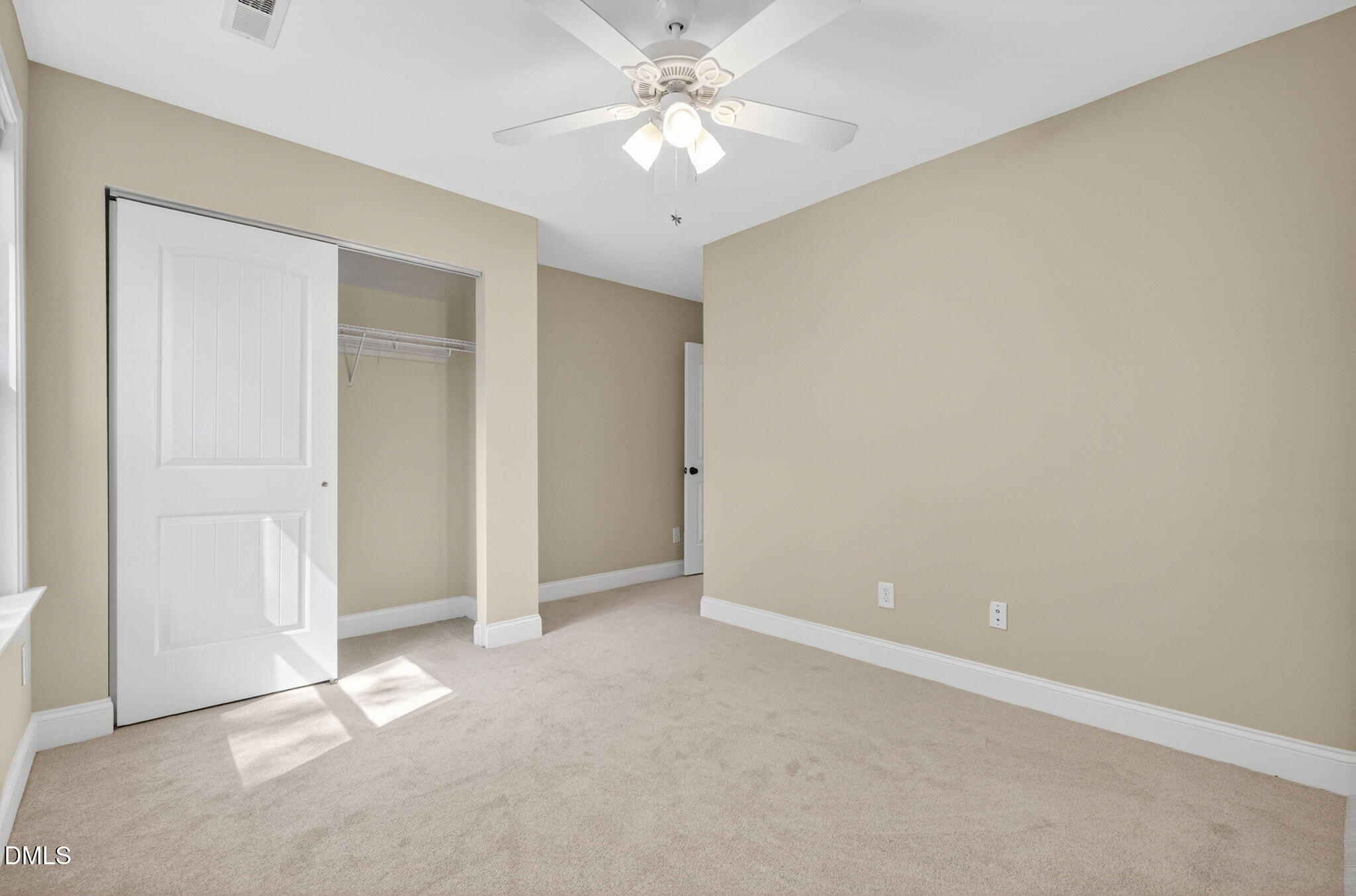 1304 Barnford Mill Road Wake Forest, NC 27587 - Photo 37 of 44 an empty room with closet and a chandelier fan