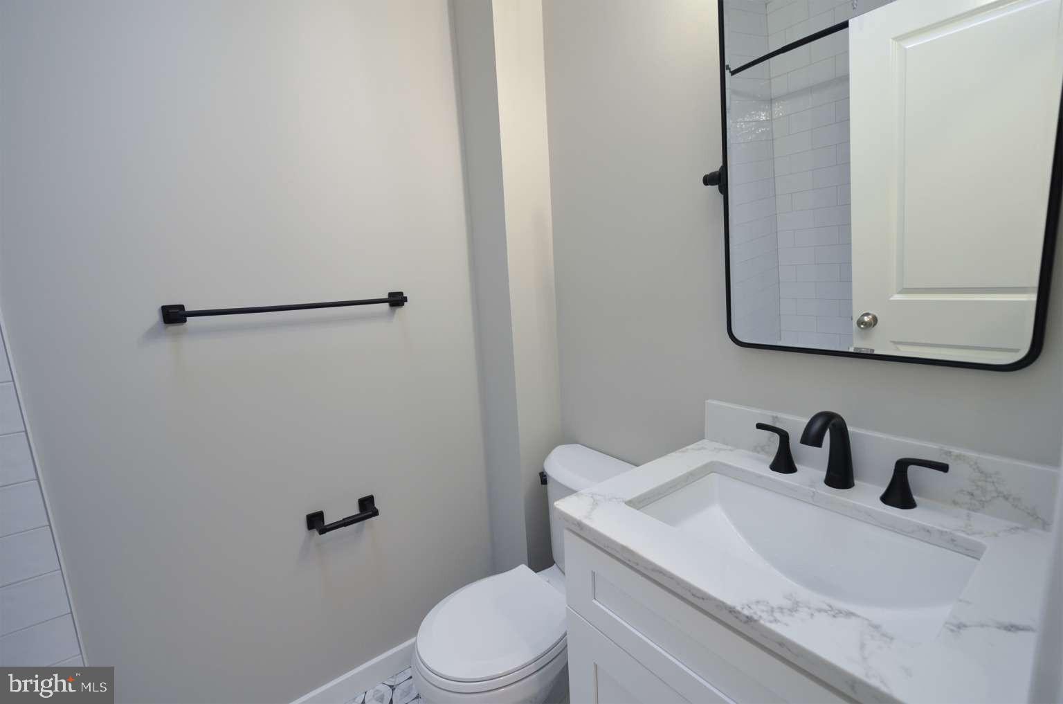 8213 Colfax Street Philadelphia, PA 19136 - Photo 14 of 25 a bathroom with a sink a toilet and a mirror