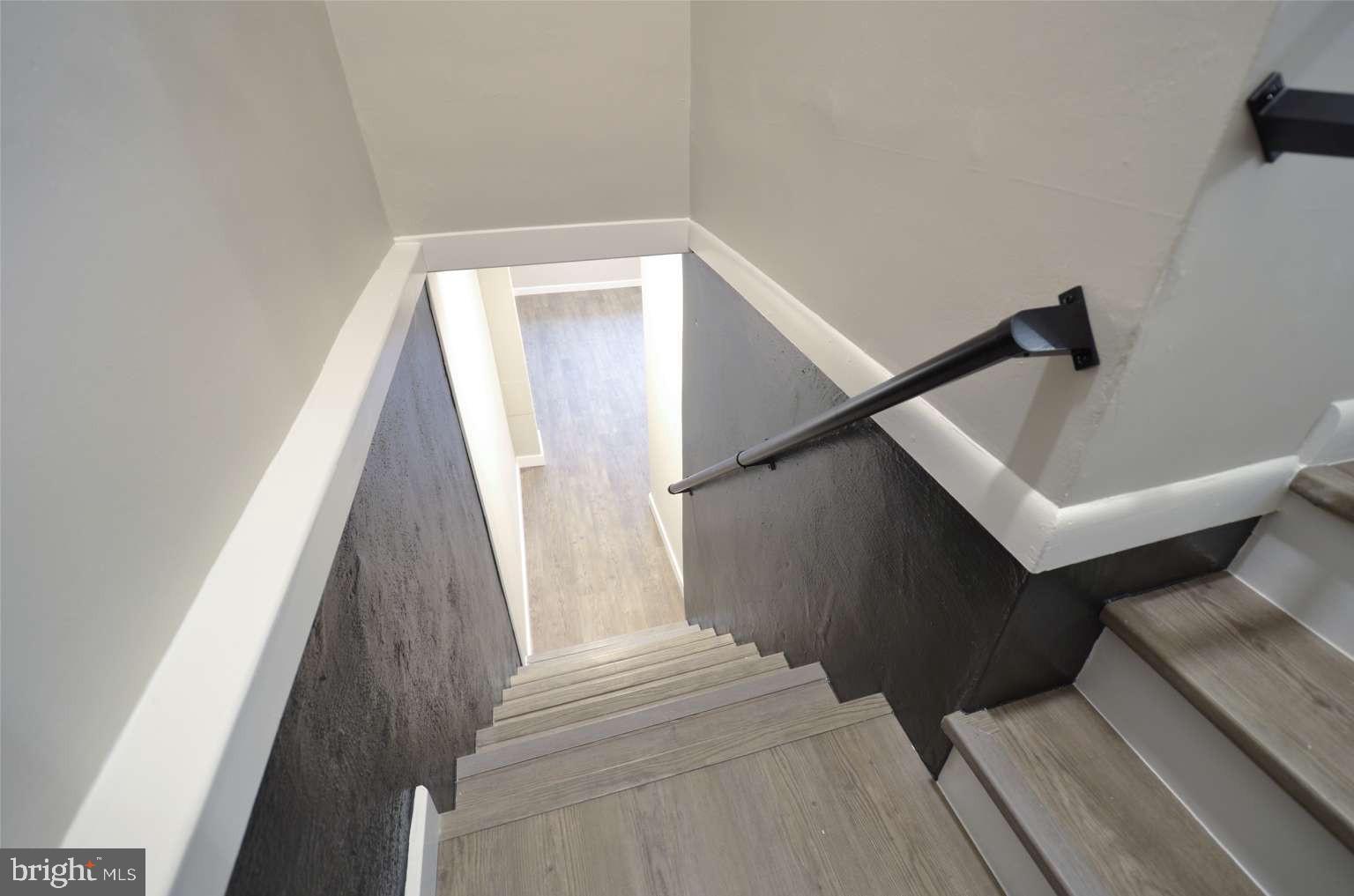 8213 Colfax Street Philadelphia, PA 19136 - Photo 16 of 25 a view of staircase with white walls and black door