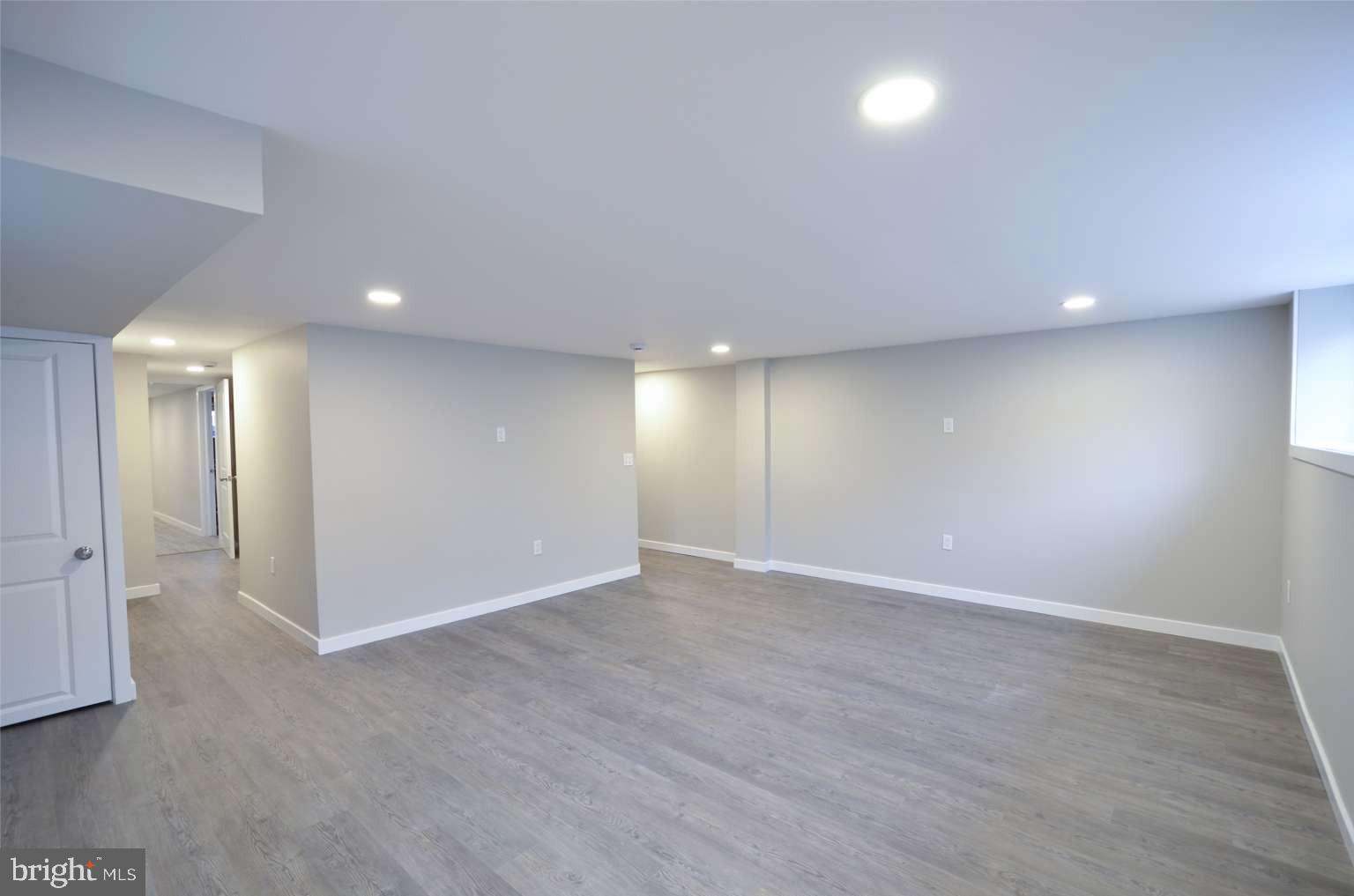 8213 Colfax Street Philadelphia, PA 19136 - Photo 18 of 25 an empty room with wooden floor and windows