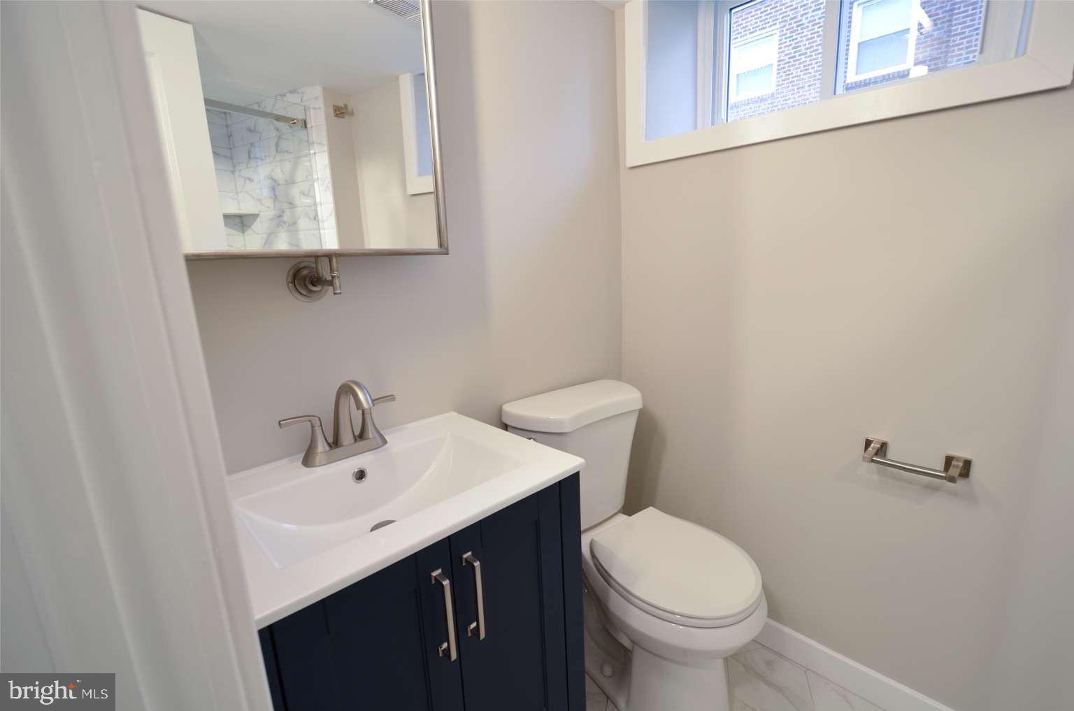 8213 Colfax Street Philadelphia, PA 19136 - Photo 22 of 25 a bathroom with a sink a toilet and mirror