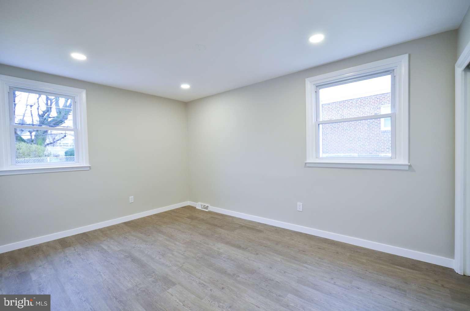 8213 Colfax Street Philadelphia, PA 19136 - Photo 9 of 25 a view of empty room with wooden floor and fan