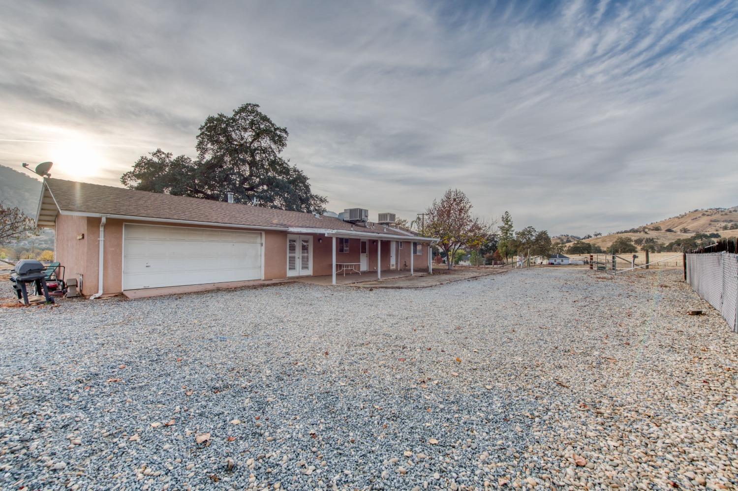 8062 Monreal Drive Sanger, CA 93657 - Photo 2 of 24 a view of a house with a backyard