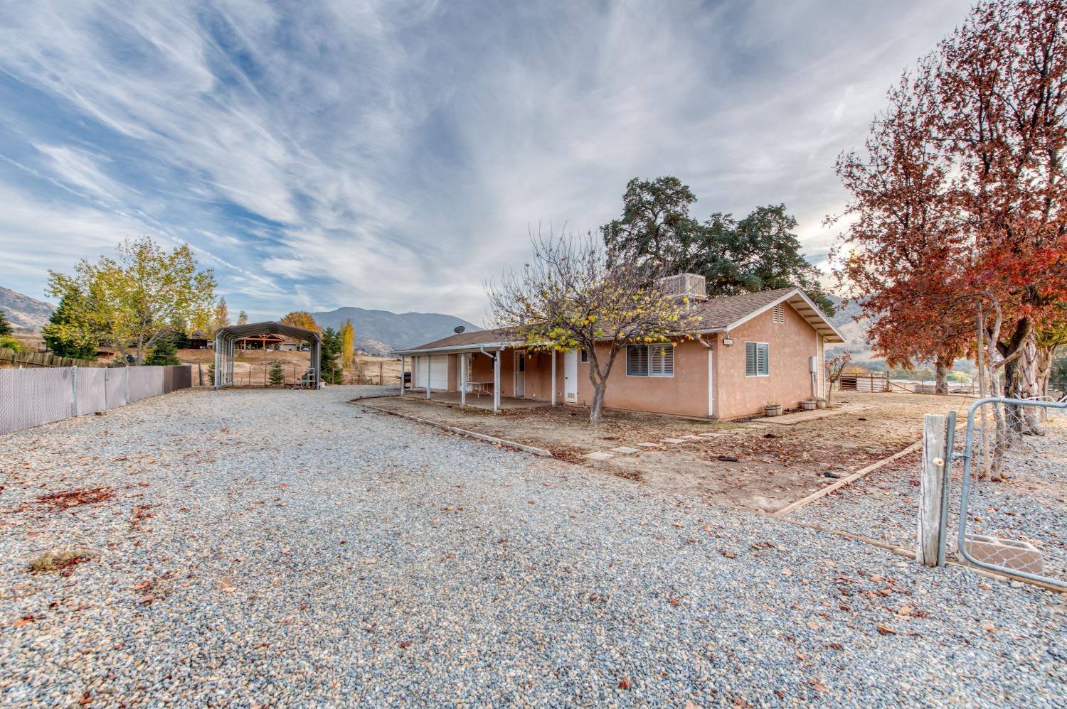 8062 Monreal Drive Sanger, CA 93657 - Photo 22 of 24 a front view of a house with a yard