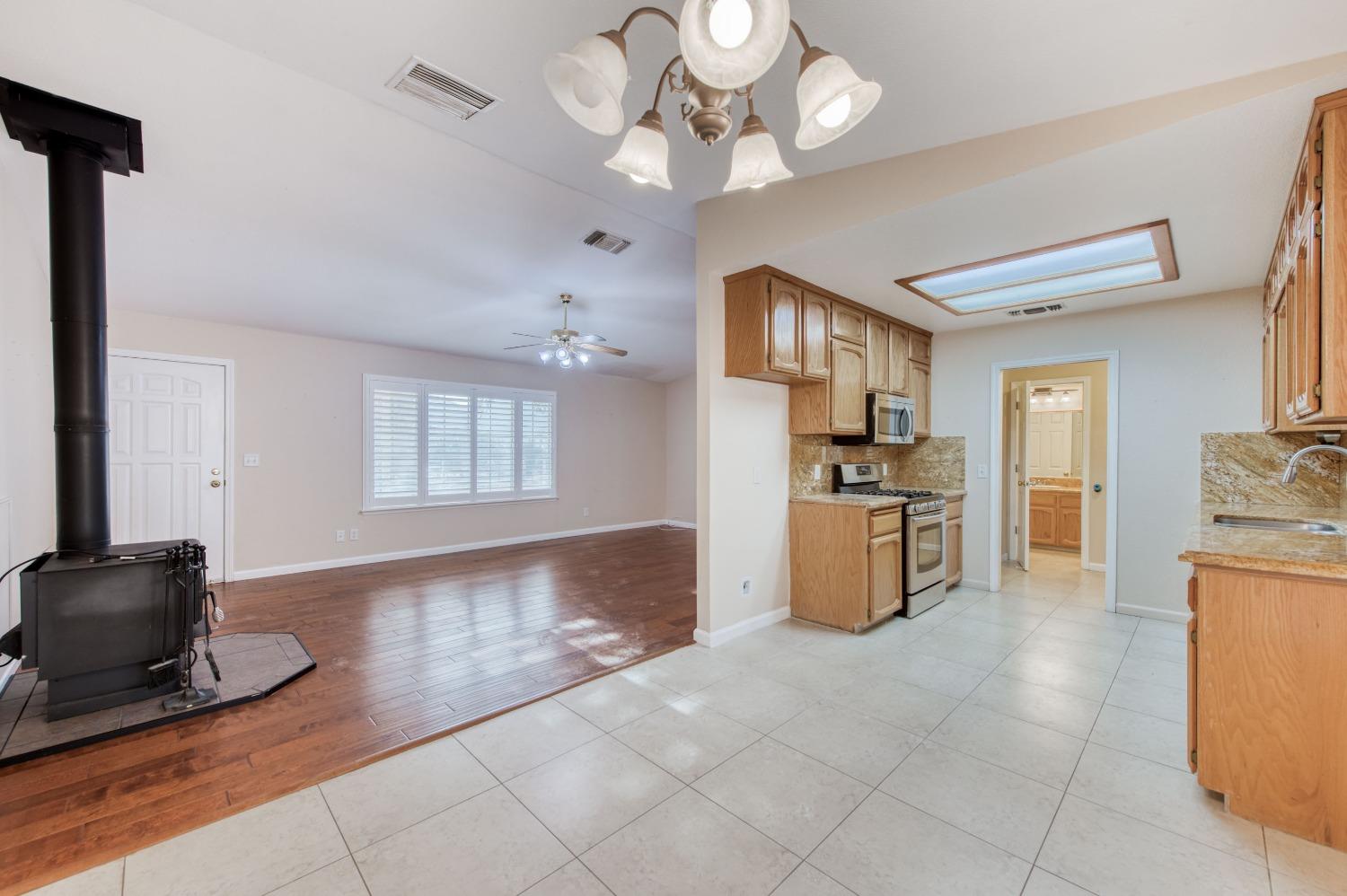8062 Monreal Drive Sanger, CA 93657 - Photo 8 of 24 a kitchen with stainless steel appliances granite countertop a refrigerator a stove a sink and a refrigerator