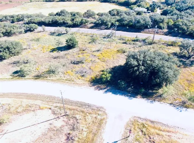 a view of a yard with snow on the road