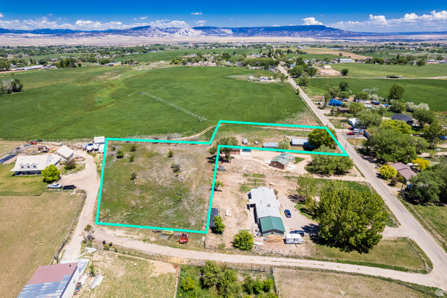 1043 East 4000th Street South Vernal, UT 84078 - Photo 28 of 31 Expansive lot with visible property lines, featuring undeveloped land, established trees, and surrounding agricultural fields
