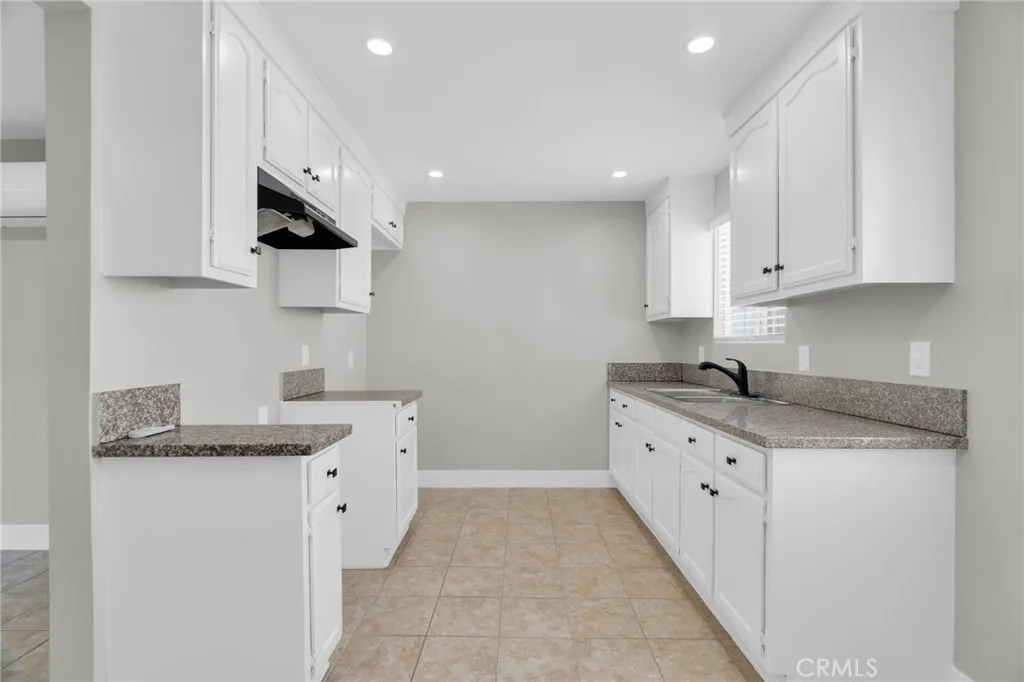 5828 Whitsett Avenue Valley Village, CA 91607 - Photo 12 of 27 a kitchen with granite countertop a sink and a stove