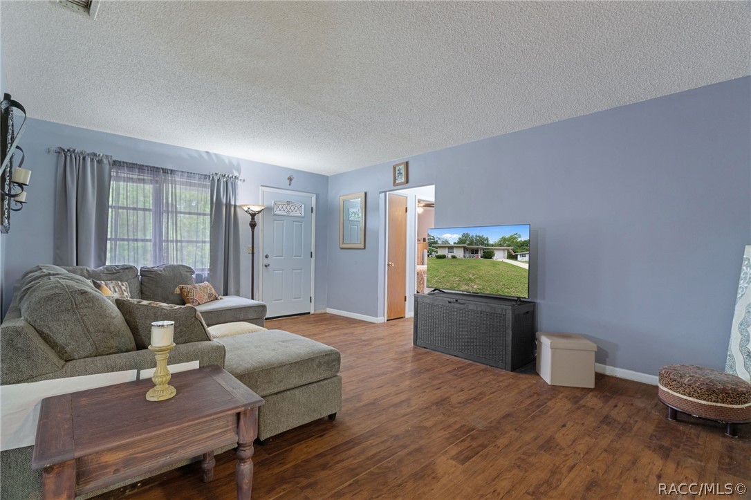 3355 South Highlands Avenue Inverness, FL 34452 - Photo 8 of 30 a living room with furniture and a wooden floor