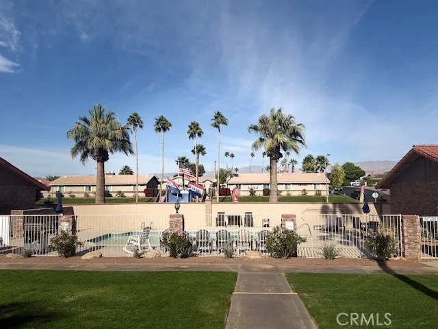 a view of a house with a big yard and large trees