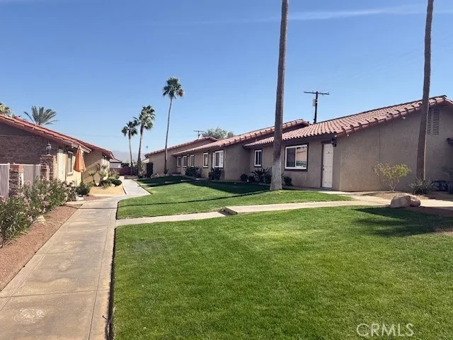 a swimming pool with yard in front of it