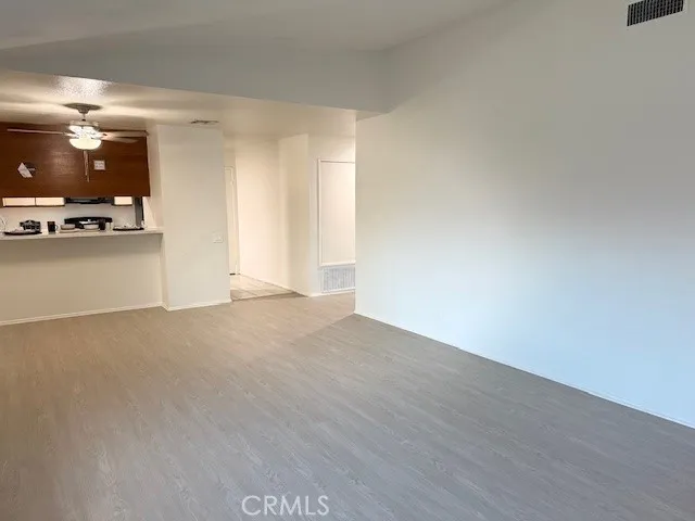 a view of a kitchen with a sink and a refrigerator