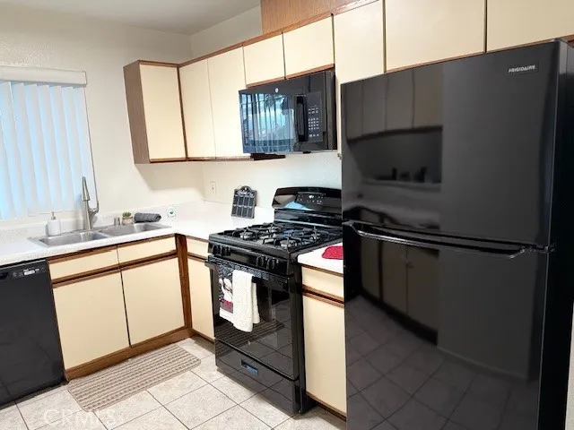 a kitchen with stainless steel appliances a stove a sink and a microwave